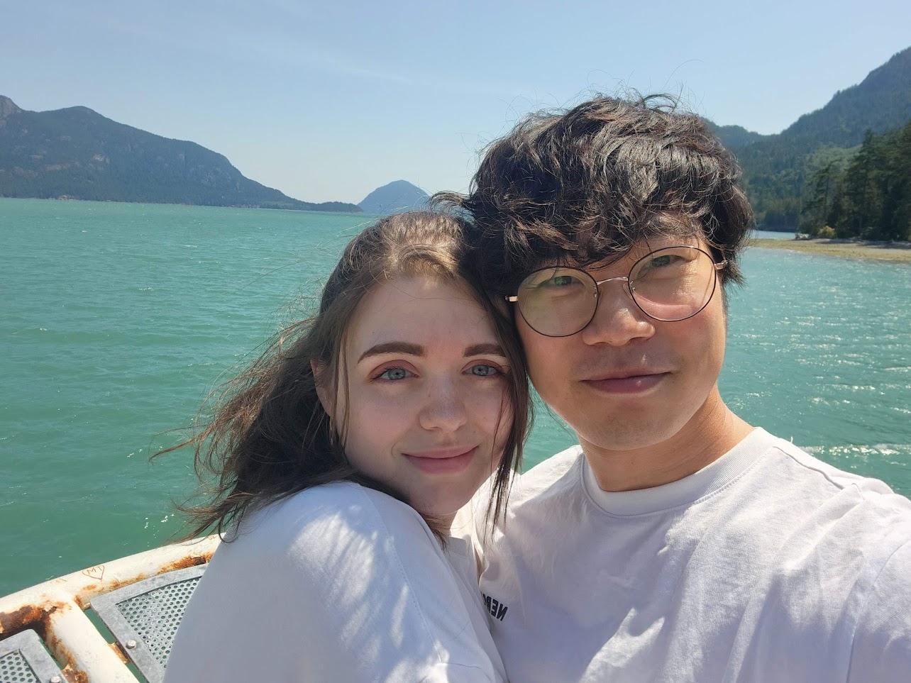 The couple posing beside a lake in Squamish