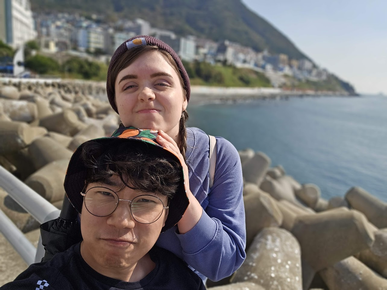 The couple taking a photo by the sea in Busan