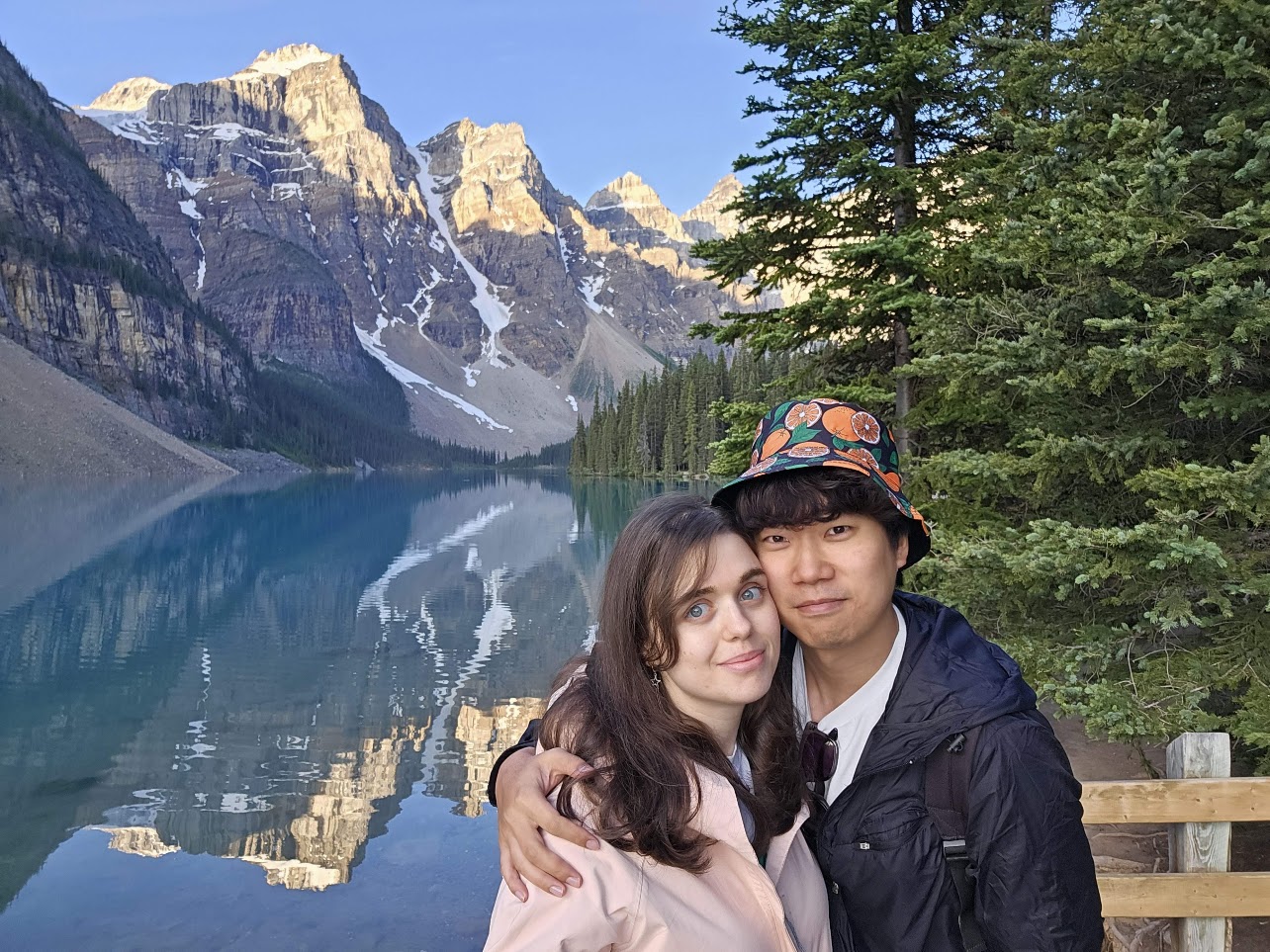 The couple posing beside a mountain lake in Banff