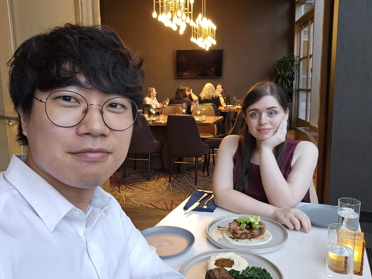 The couple sitting across from each other on the day of the proposal