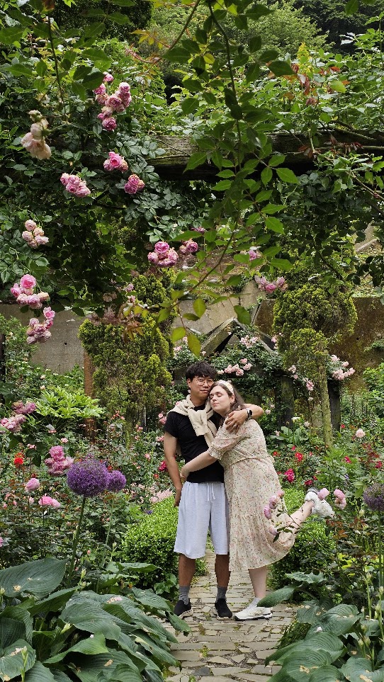The couple posing in a flower garden during a trip to Japan