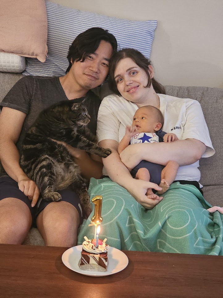 The family of three and Cookie celebrating Youngjoon's first month
